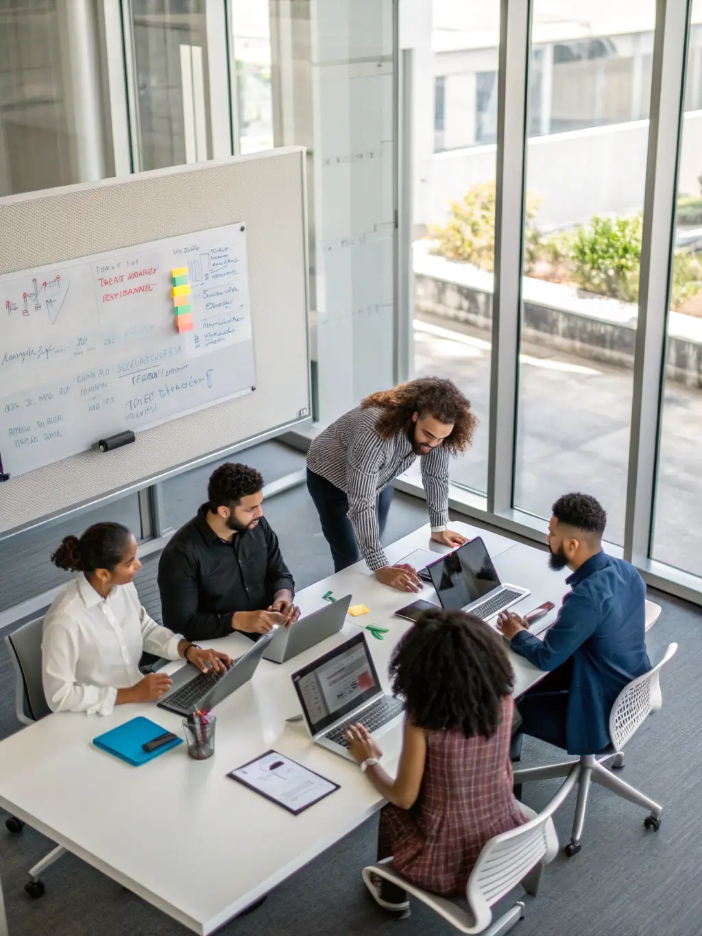 A diverse team of DataTel 360 support staff collaborating to solve a complex telecom issue, showcasing comprehensive support.